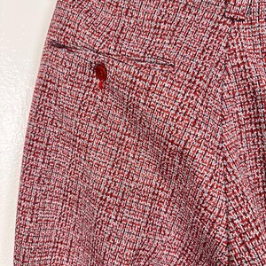 May include: Red and white patterned pants with a back pocket.