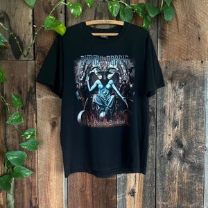 May include: Black t-shirt featuring a band graphic print of "Darkthrone" with the text "In Sorte Diaboli".