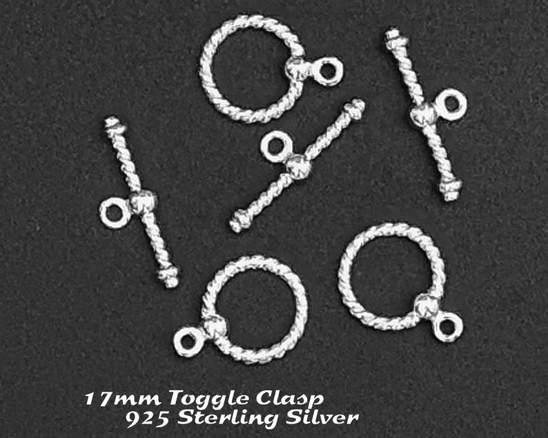 May include: Five silver toggle clasps with a rope-like design. The clasps are 17mm in size and are made of 925 sterling silver.