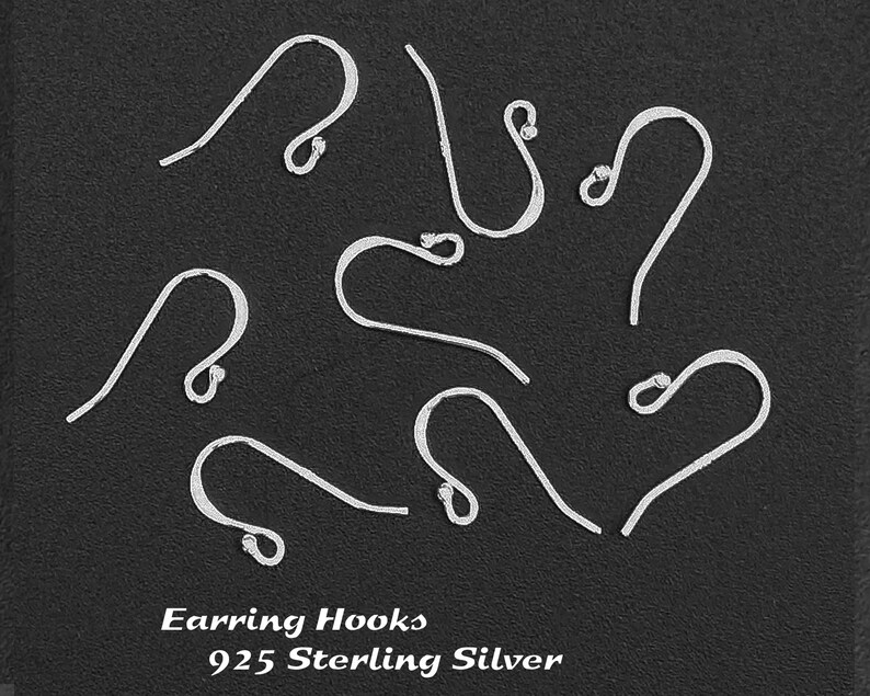 May include: Nine silver earring hooks made of 925 sterling silver. The hooks are arranged in a circle on a black background.