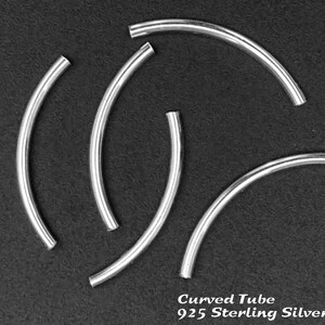May include: Five silver curved tube beads, made of 925 sterling silver. The beads are arranged in a circular pattern on a black background.
