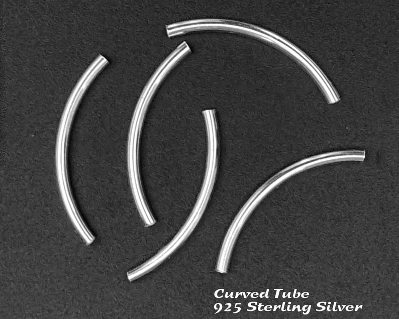May include: Five silver curved tube beads, made of 925 sterling silver. The beads are arranged in a circular pattern on a black background.