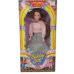 May include: A rustic wooden sign with the text "Welcome to our home" in white lettering. The sign has a distressed finish and a simple, inviting design, suitable for a front porch or entryway.