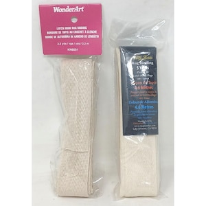 May include: Two packages of off-white latch hook rug binding tape. The left package is labelled WonderArt with 3.2 metres. The right package is labelled Rug Binding with 4.6 metres. Both are made of a woven cotton herringbone fabric tape.
