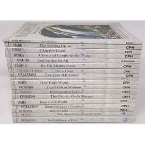 May include: A stack of books with white covers and titles such as "Philippians," "Mark," and "Ezekiel." The books have titles in black text and the publisher's logo, "CPH," is visible on the right side of the books.