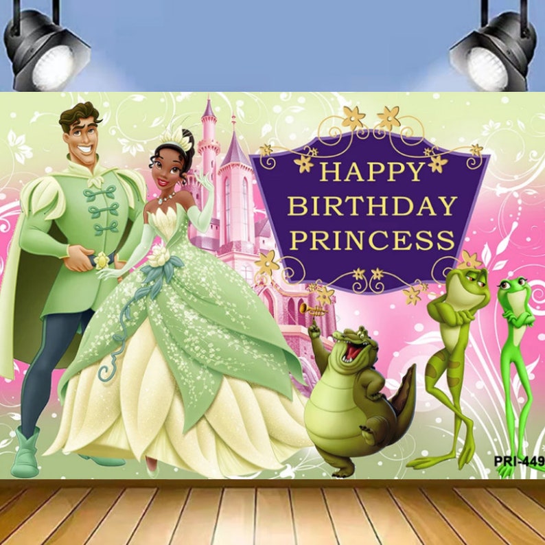 May include: A green and pink birthday backdrop with a castle, a prince, a princess, a frog, and a crocodile. The text on the backdrop reads 'Happy Birthday Princess'.