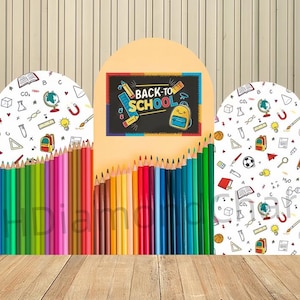 May include: A colorful back-to-school display featuring a chalkboard with the text "BACK-TO-SCHOOL" and a yellow backpack illustration. The display includes a row of colored pencils and decorative panels with school-themed patterns.