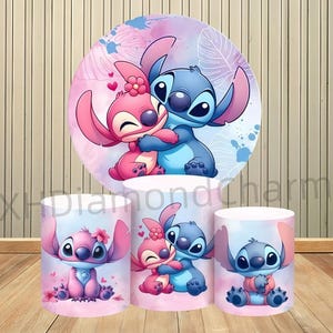 May include: A vibrant display featuring the characters Stitch and Angel from Lilo & Stitch. The design includes a large circular backdrop and three cylindrical stands, all adorned with the characters in a loving embrace, set against a pink and blue watercolor background.