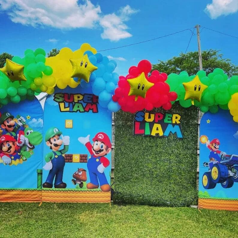 May include: Two blue and green backdrops with the text "Super Liam" and images of Mario characters. The backdrops are decorated with green, red, yellow, and blue balloons.