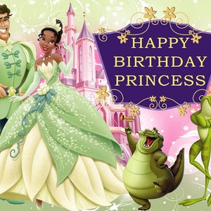 May include: A birthday card featuring a green and white princess and a prince in a green suit. The card has a purple banner with gold stars and the text 'HAPPY BIRTHDAY PRINCESS'. There are also two green frogs and a green alligator in the image.