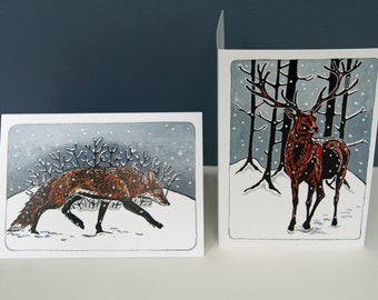 Pack of 8 Christmas cards of 2 linocut designs featuring a Winter Stag and a Snowy Fox