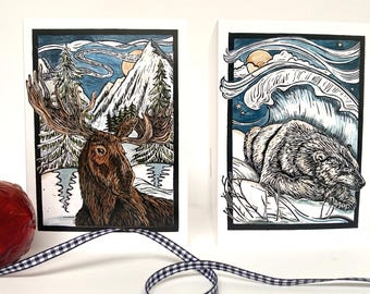 Pack of eight Christmas cards, 2 designs featuring a moose and a polar bear
