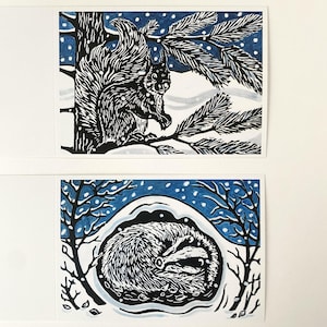 Pack of 8 linocut design Christmas cards featuring a sleeping badger and a red squirrel.