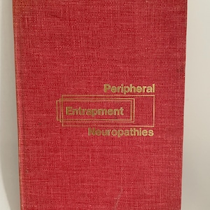 May include: A red book with gold lettering. The title reads "Peripheral Entrapment Neuropathies". The book has a textured cover and appears to be a medical textbook or reference guide.