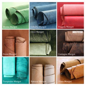 May include: Nine different colors of leather rolled up, with the name of each color written below. The colors are: Menta Margot, Cobalto Margot, Fragola Margot, Olive Margot, Fieno Margot, Castagna Margot, Turquoise Margot, Natural Margot, and Olmo Margot. The text "NOSTITCH handcrafted leathergoods" is in the upper right corner.