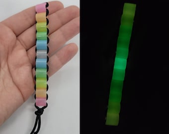 Juguete antiestrés de dedo con cuentas grandes que brillan en la oscuridad