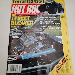May include: A magazine cover for Hot Rod magazine featuring a blue and silver street blower car with the text "The Street Blower" and "Tests: 6-71s, 4-71s, B&M, Magna Charger".