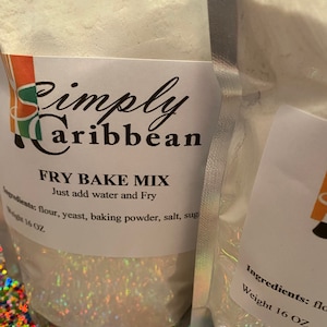 May include: A white bag of Simply Caribbean Fry Bake Mix. The bag is labeled with the ingredients: flour, yeast, baking powder, salt, and sugar. The bag is 16 ounces.