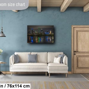 May include: A living room size chart showing a 30x45 inch / 76x114 cm print of a cityscape at night. The print shows a skyline with tall buildings and a reflection of the city lights in the water.