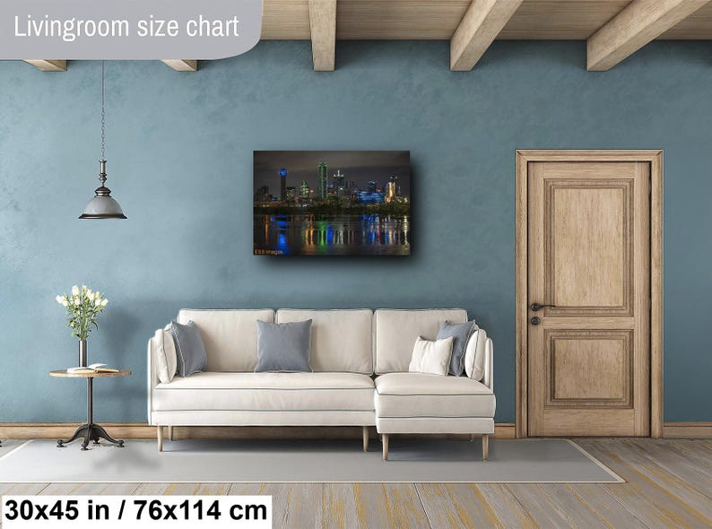 May include: A living room size chart showing a 30x45 inch / 76x114 cm print of a cityscape at night. The print shows a skyline with tall buildings and a reflection of the city lights in the water.