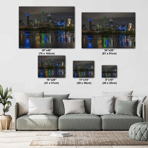 May include: A collage of five different sizes of a photograph of the Austin, Texas skyline at night. The skyline is lit up in blue, green, and white lights, reflecting in the water below. The image is available in sizes ranging from 8x10 inches to 30x40 inches.