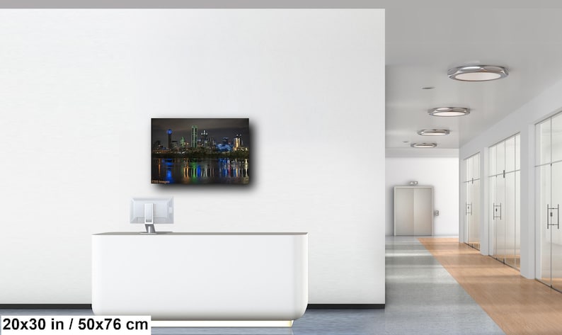 May include: A nighttime cityscape photograph of Dallas, Texas, with the city skyline reflected in the water. The buildings are illuminated with colorful lights, creating a vibrant and dynamic scene. The image is 20x30 inches or 50x76 centimeters.