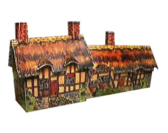 May include: Two miniature cardboard houses with thatched roofs, painted in a rustic style with brown, yellow, and white accents. The houses have chimneys and windows, and the front of the houses are decorated with flowers and greenery.