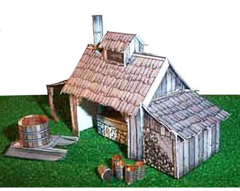 May include: A paper model of a wooden cabin with a thatched roof, a chimney, and a wood-burning stove. The cabin is surrounded by a small yard with a wooden barrel and a pile of logs.