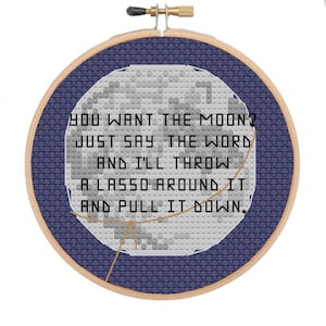 May include: A cross-stitch embroidery hoop with a blue background and a white moon with a lasso around it. The text reads "You want the moon? Just say the word and I'll throw a lasso around it and pull it down."