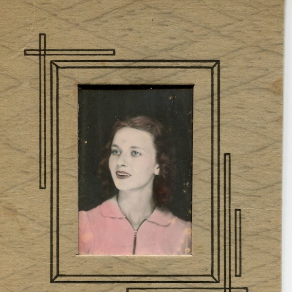 Nice hand-colored photo booth portrait of young lady in board frame. Small 1920s or 30s vintage original vernacular snapshot photo.