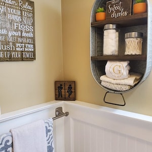 Galvanized Washtub with shelves stained in a dark walnut stain with two shelves and hung on the wall in your rustic farmhouse bathroom and or laundry room!