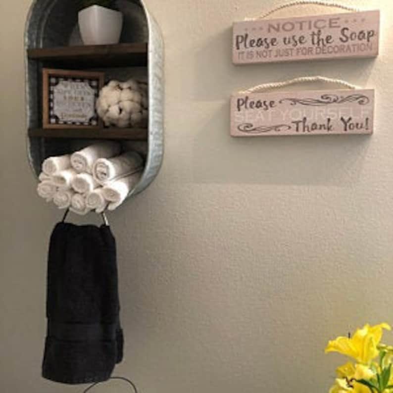 Galvanized Washtub with shelves stained in a dark walnut stain with two shelves and hung on the wall in your rustic farmhouse bathroom and or laundry room!