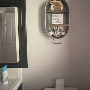 Galvanized Washtub with shelves stained in a dark walnut stain with two shelves and hung on the wall in your rustic farmhouse bathroom and or laundry room!