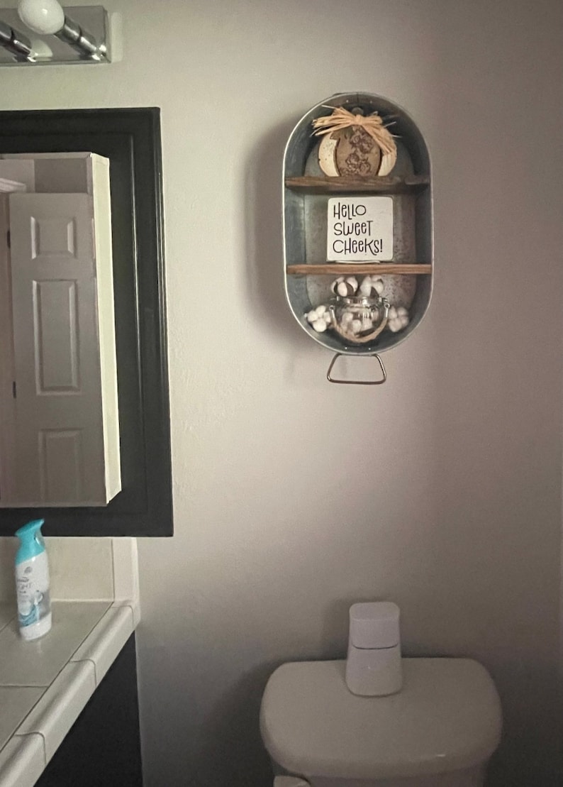 Galvanized Washtub with shelves stained in a dark walnut stain with two shelves and hung on the wall in your rustic farmhouse bathroom and or laundry room!