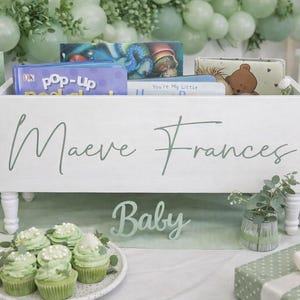 May include: A handmade wooden sign with the text "Welcome to our home" in a handwritten style. The sign is painted white with a distressed finish and features a decorative floral design. It is designed to be hung on a wall.