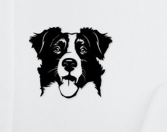 May include: Black and white metal wall art of a dog's face. The dog has a white patch on its face and a black coat. The dog's tongue is visible. The art is mounted on a white wall.