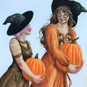 May include: Two women wearing witch hats and brown dresses hold orange pumpkins. One woman has pink hair and the other has brown hair.