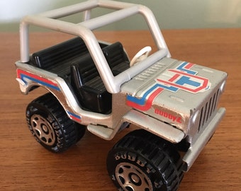 Vintage 1980 Buddy L Jeep Renegade.  Pressed steel and plastic.  Silver with blue & red foil  stickers.  Made in Japan.  Good condition.