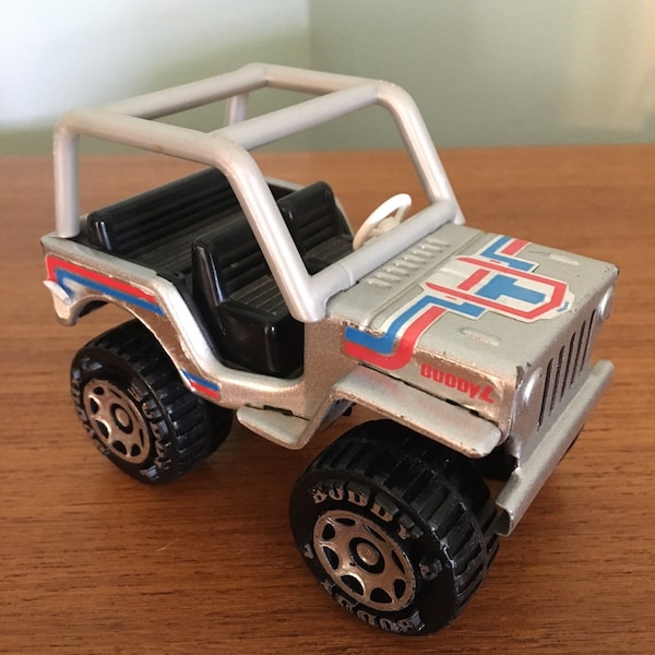 Vintage 1980 Buddy L Jeep Renegade.  Pressed steel and plastic.  Silver with blue & red foil  stickers.  Made in Japan.  Good condition.