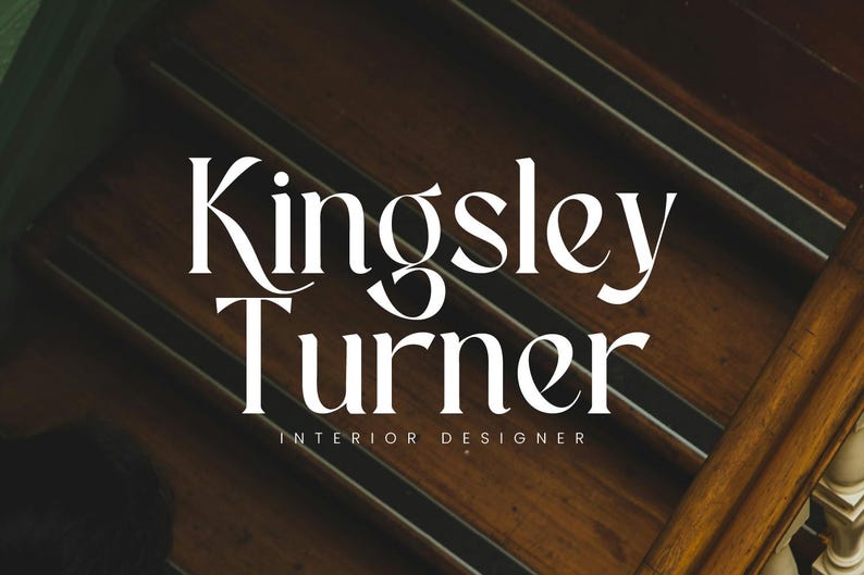 Puede incluir: La imagen presenta el texto "Kingsley Turner, Interior Designer" en una fuente blanca y elegante. El texto se establece sobre un fondo de una escalera de madera oscura con una barandilla.