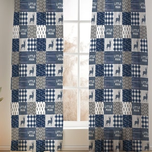 May include: A pair of blue and gray curtains with a patchwork design featuring a repeating pattern of deer and the words "Little Man".