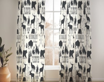 May include: Black and white patterned curtains featuring a woodland theme with silhouettes of animals, trees, mountains, and a campfire. The text "The mountains are calling and I must go" and "Be courageous, be brave" are repeated throughout the pattern.