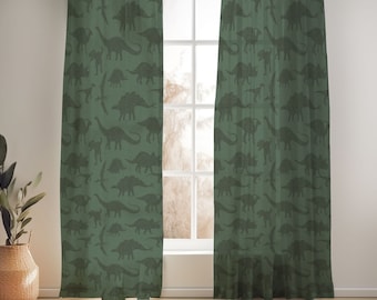 May include: A pair of green curtains with a dinosaur pattern. The curtains are hanging in a window and are made of a sheer fabric.