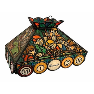 May include: A stained glass billiard table lamp with a geometric shape. The lamp features a colorful design of pool players and pool balls. The lamp has a metal frame and is designed to hang from the ceiling.