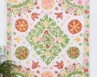 May include: White tapestry with a floral design in shades of green, orange, pink, and yellow. The design features a central diamond shape with four circles in the corners.