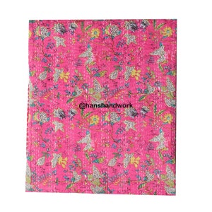 May include: Pink kantha quilt with a floral and bird pattern. The quilt is hand-stitched and features a variety of colours, including pink, yellow, green, and blue. The quilt is made of cotton and is perfect for adding a touch of bohemian style to any room.