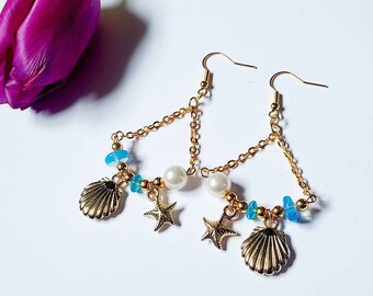 Gold ocean dangle earrings with starfish and sea shell charms, pearl and blue glass bead sea themed earrings for women, beach jewellery