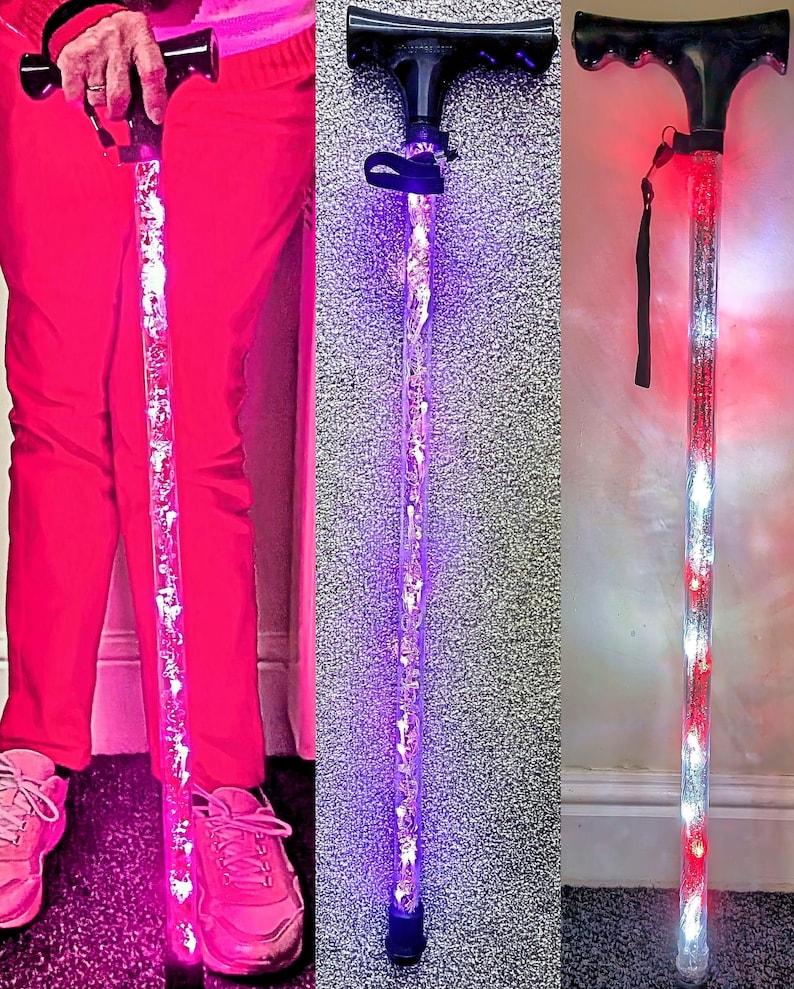 May include: Light-up walking canes with black handles and clear shafts filled with decorative elements. The canes feature LED lights in pink, purple, and red and white. The canes are designed for mobility and visibility.