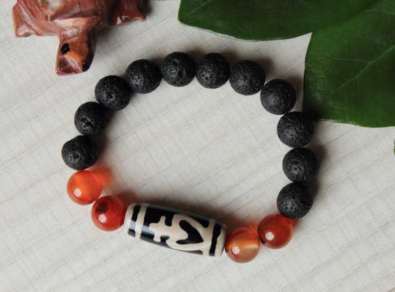 Amulet of wealth and protection.Luck bracelet of Bead Dzi a vessel of abundance and 10mm sardonyx lava beads.Magic bracelet of gemstones.