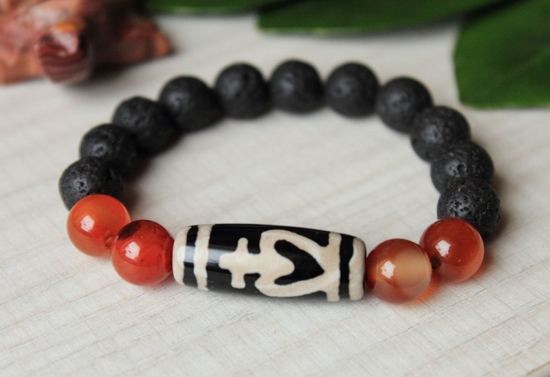 Amulet of wealth and protection.Luck bracelet of Bead Dzi a vessel of abundance and 10mm sardonyx lava beads.Magic bracelet of gemstones.